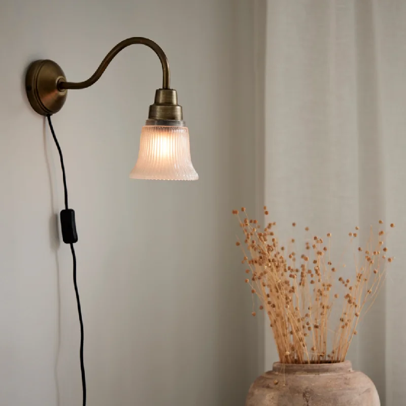 metal wall lamps with a matte black finish for a sleek and modern lookWall lamp Emmi, antique brass